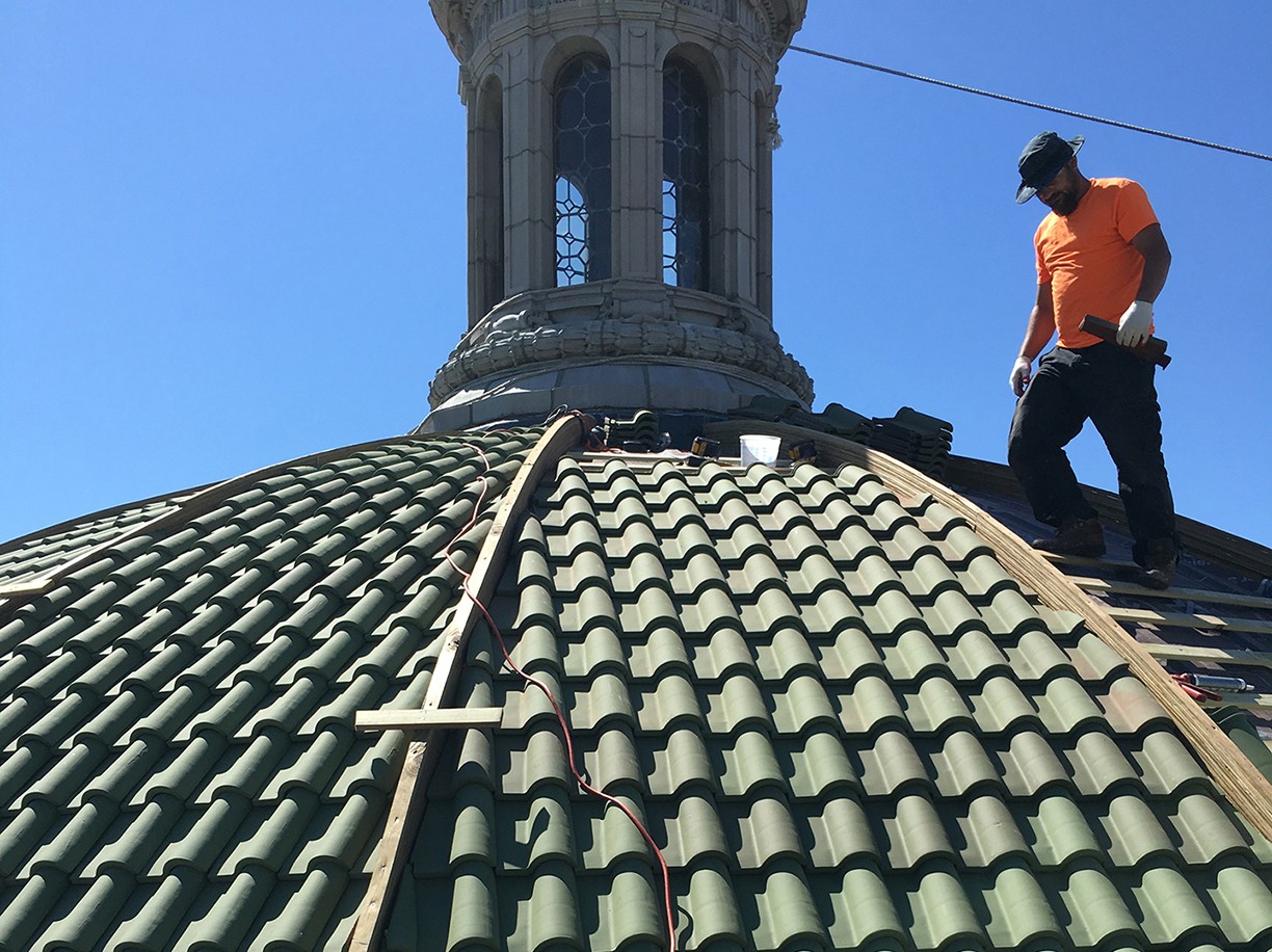 Installation of the replacement tiles, crafted from the original molds, commenced in July