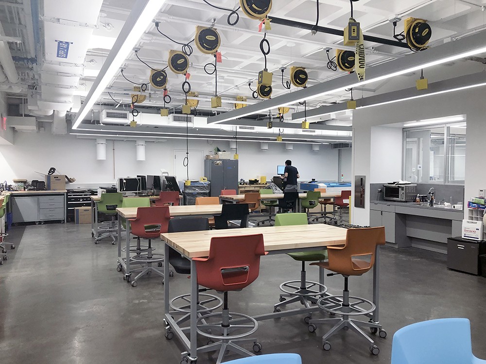 The interior of the new Innovation Foundry with tables, chairs, and research equipment