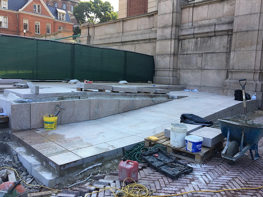 Granite is being installed at the new, accessible ramp at Low Plaza.