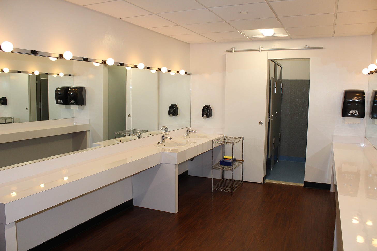 A renovation to the Miller Theatre dressing rooms included dropped ceilings with new tiles and LED light fixtures, an upgraded restroom, and new flooring. 