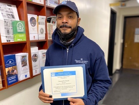 photo of man holding up perfect attendance certificate