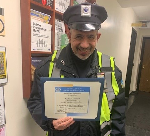 Security Officer Pericles Almanzar Celebrates 11 Years of Perfect Attendance photo of man in Public Safety uniform holding up perfect attendance certificate