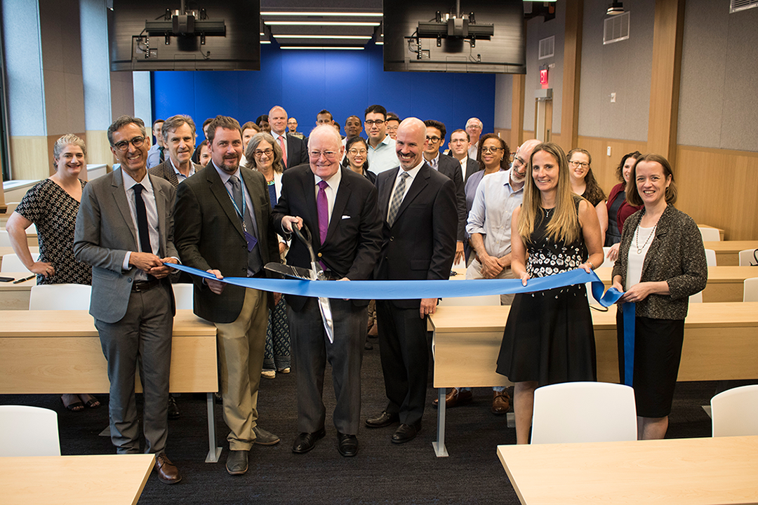 In 402 Chandler, Provost John Coatsworth, center, cuts the ribbon held by CUFO Executive Director for Space Planning Eugene Villalobos, Project Manager Jason Cea, Executive Vice Provost Troy Eggers, Columbia Health AVP and Medical Director Melanie Bernitz, and Deputy Registrar Monica Avitsur.