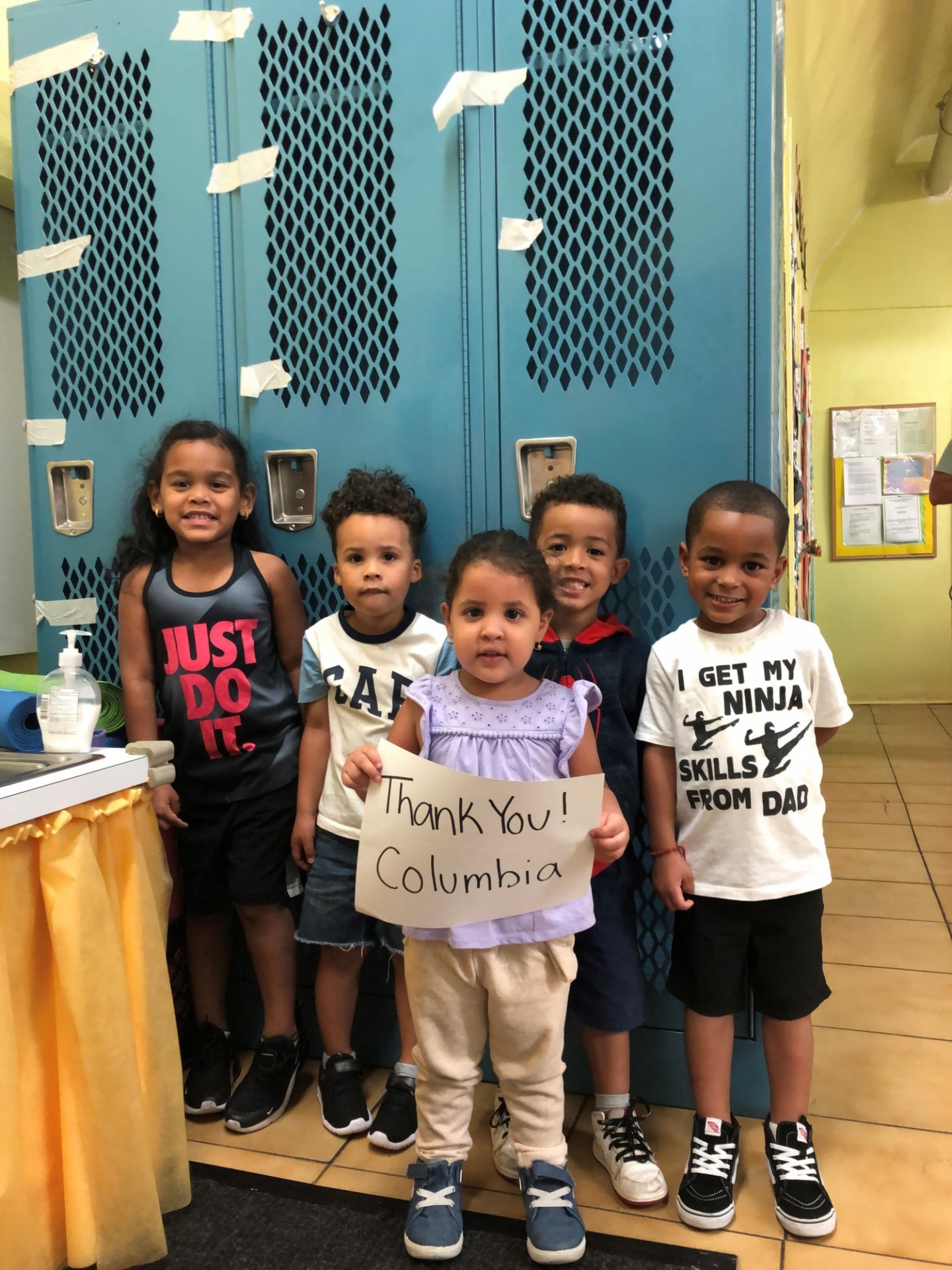 Washington Heights Child Care Center members in front of the donated lockers. From left: Keylee Martinez, Angel Matteo Recio, Charlotte Coenao, Aiden Espinal, Artdy Hernandez