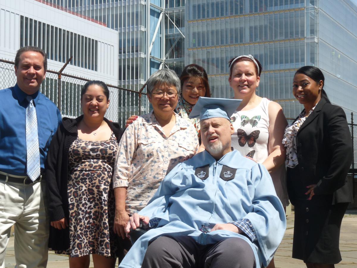 Edward Lauth (seated) surrounded by the friends, family and colleagues who helped him get through a degree program and breast cancer.