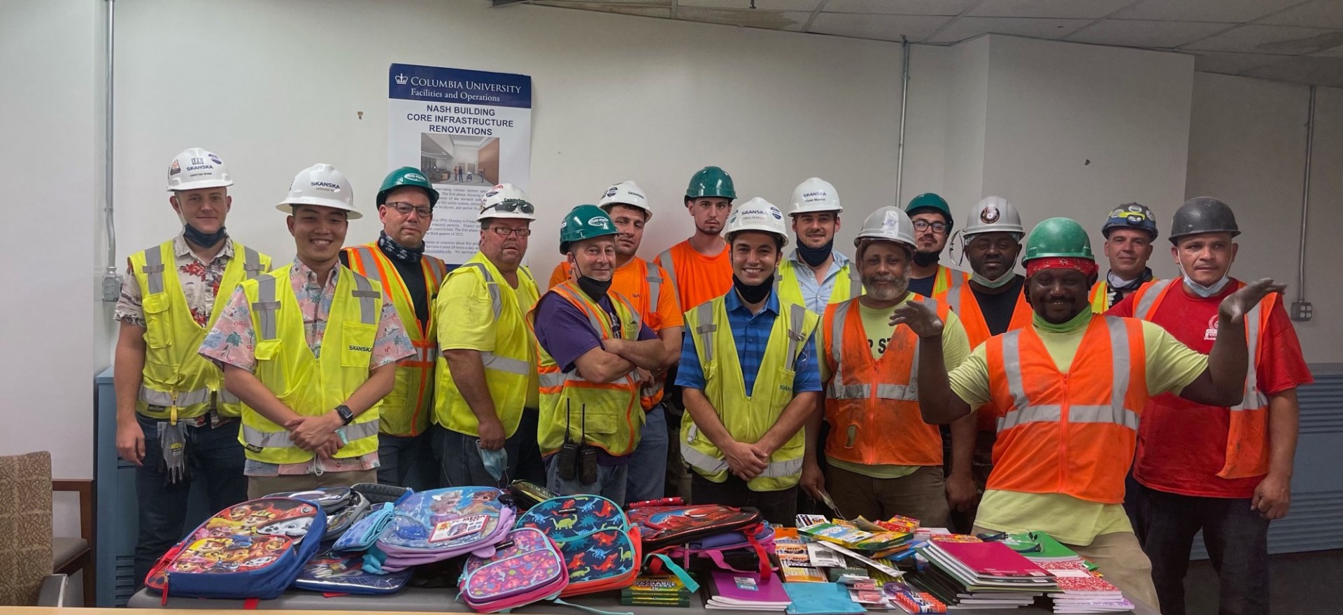 Facilities and Operations construction workers posing with backpacks collected