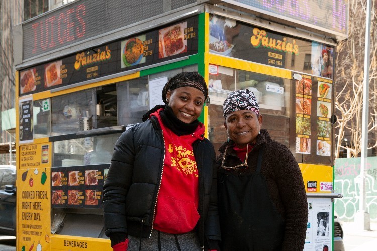 Fauzia Abdur-Rahman and her daughter Fauzia Aminah. Courtesy of Fauzia's Heavenly Delights. two women posing for photo in front of food truck