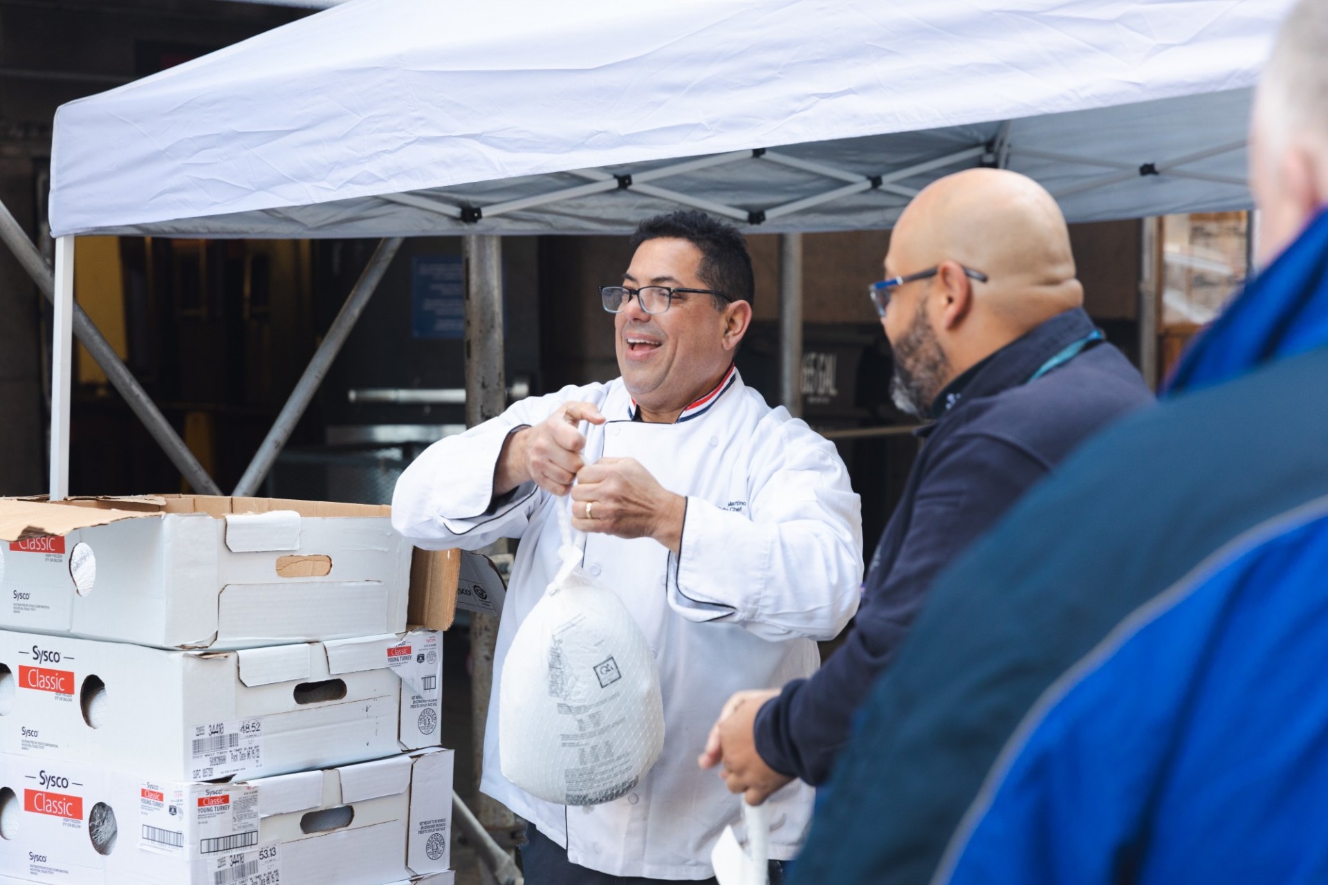 Chef Mike and Public Safety employees loading turkeys for delivery. Photo by Kevin Dale. Chef Mike and Public Safety employees loading turkeys to be delivered.