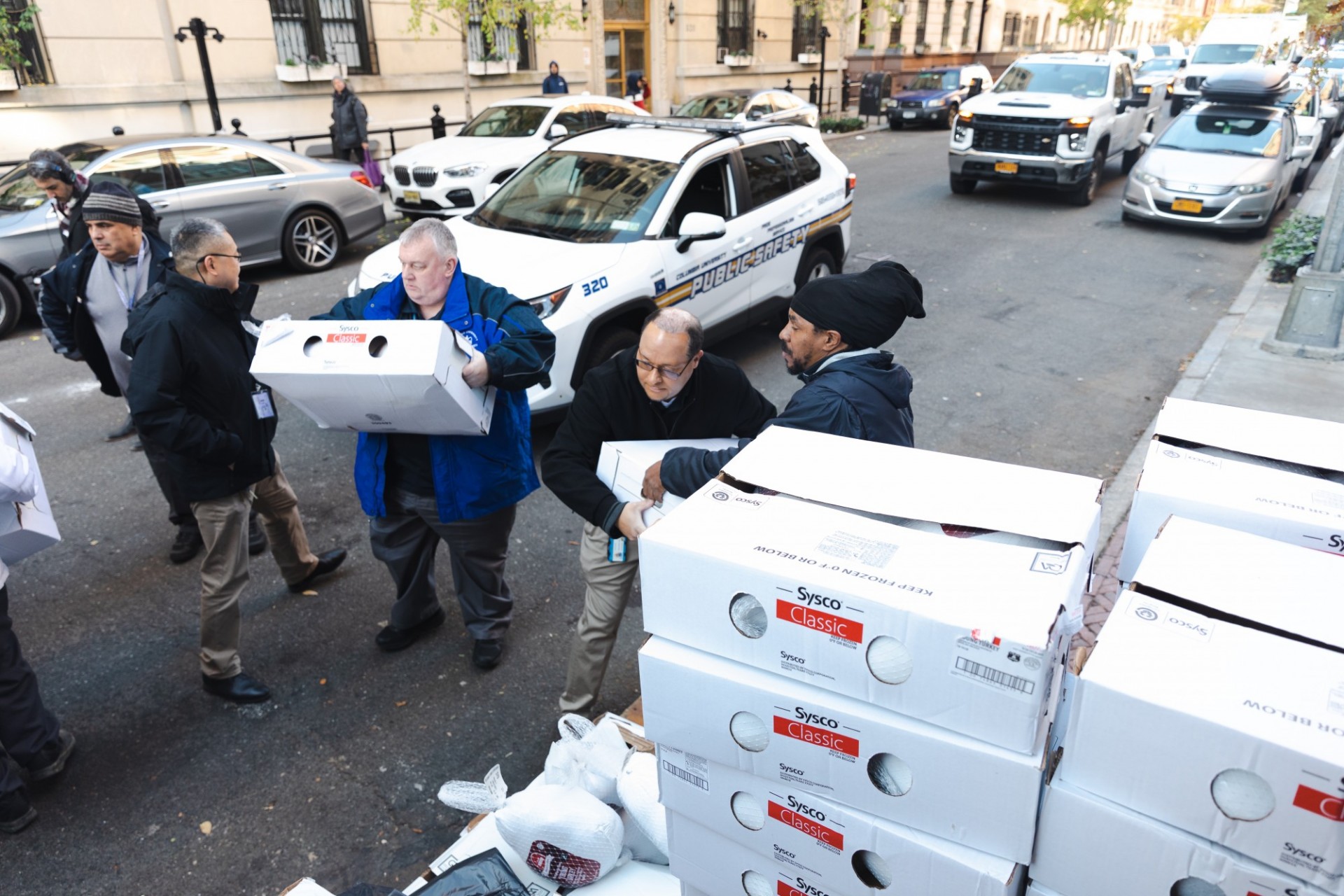 Dining and Public Safety employees loading turkeys for delivery. Photo by Kevin Dale. Dining and Public Safety employees loading turkeys for delivery.