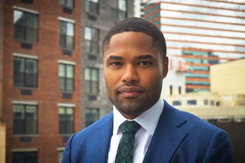 Profile photo of Aaron Weaver outdoors with buildings in the background