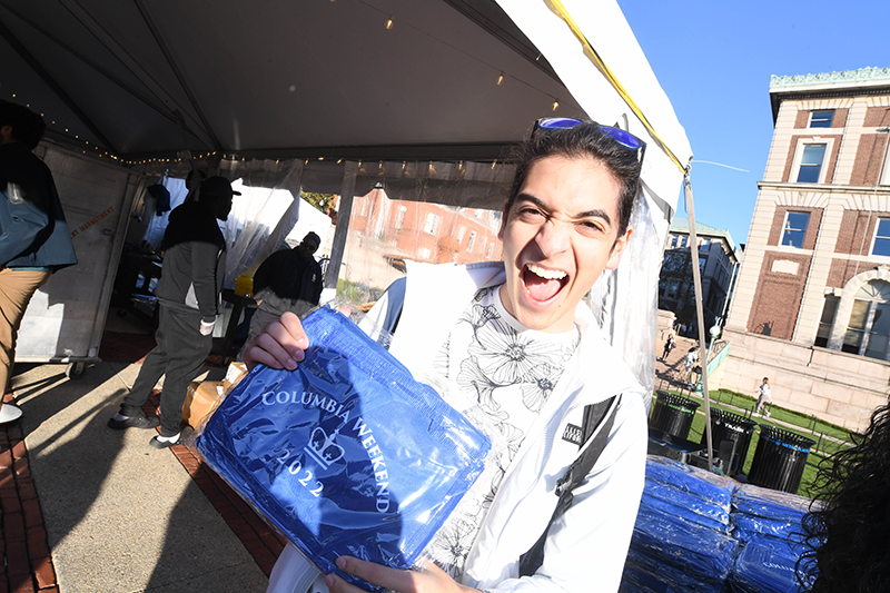 Exciting student holding event blanket