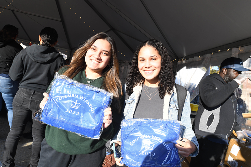 Two students holding event blanket