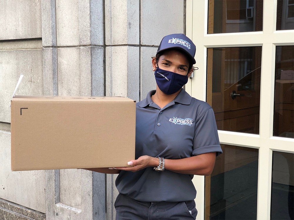 The Campus Services Express team delivered key items directly to students in residence halls from August 26 through September 19. (Photo: Columbia University Campus Services) A person with a Campus Services Express uniform delivers a package to a residence hall.