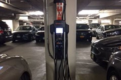 An electric vehicle charging station inside of a garage