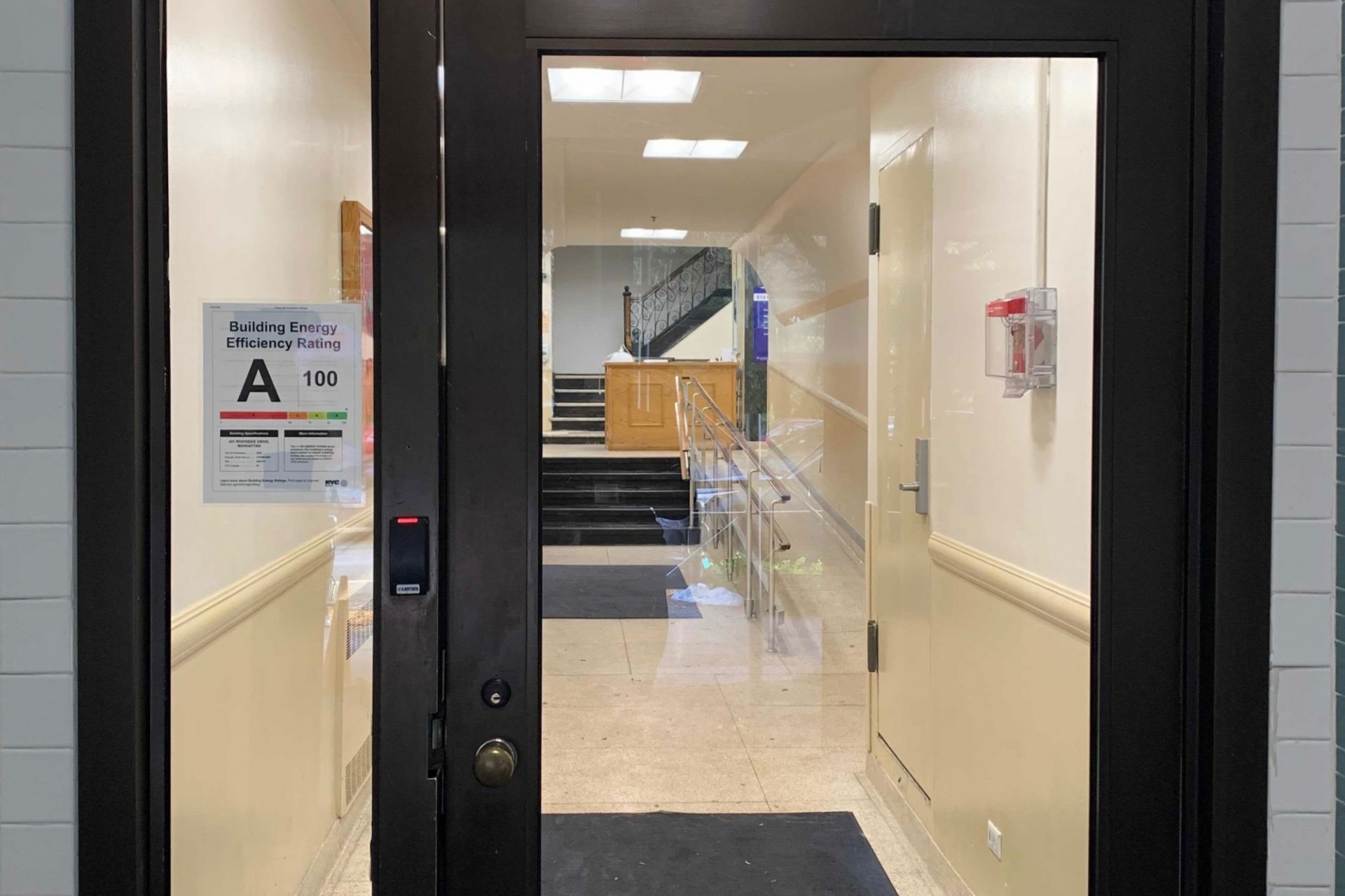 Woodbridge Hall is one of many Columbia buildings that received an A rating for energy efficiency. A glass building entrance that has a sign that lists an A grade for the building's energy efficiency rating.