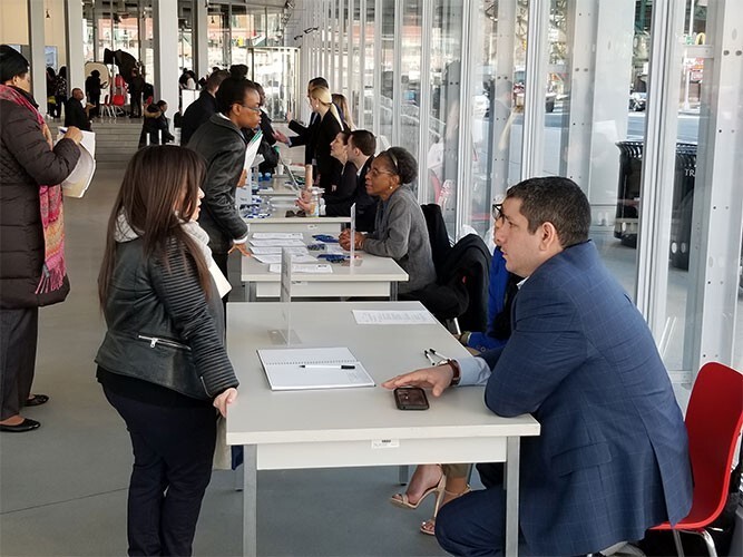 People gather in The Forum for a career expo hosted by Columbia University.