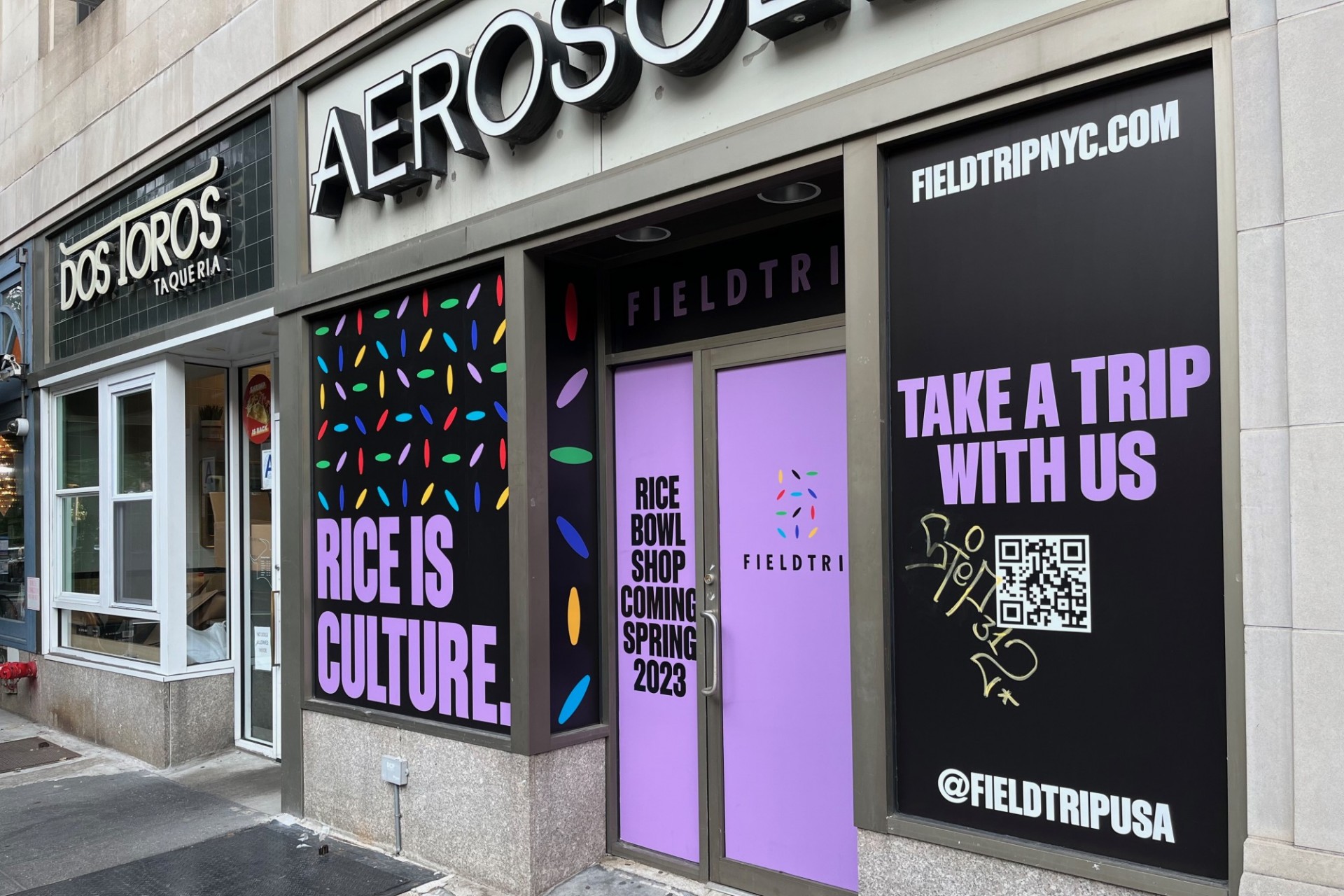 A storefront wrap that announces Fieldtrip is coming in Spring 2023 in the former Aerosoles space. 