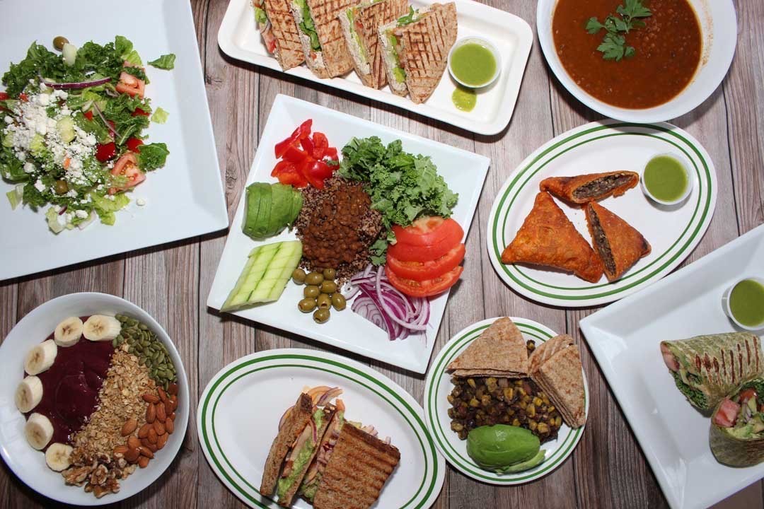 An overhead shot of Ethiopian sandwiches, salads, and soups.