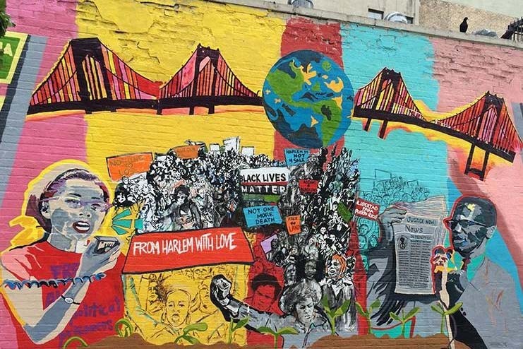 A mural on a wall dedicated to Yuri Kochiyama and Malcolm X