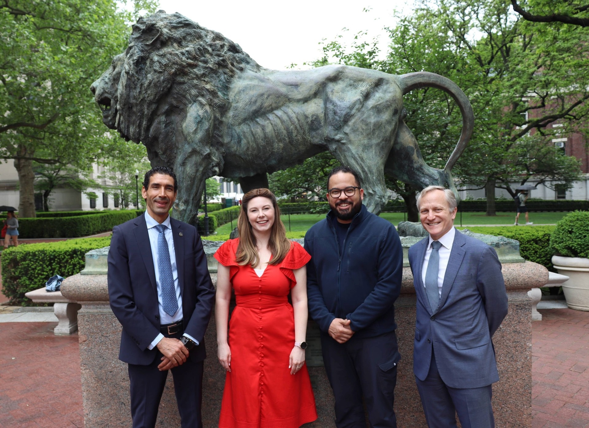 Mimoun Aoudal, Katie McCluskey, Franklin Rodriguez, and David Greenberg pose in front of Scholar's Lion on the Morningside Campus