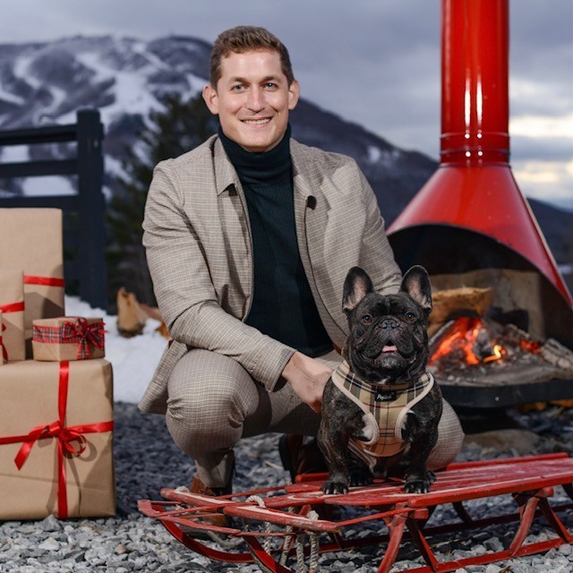 Barnaby Douglas Robinson French bulldog posing with owner in holiday themed photo
