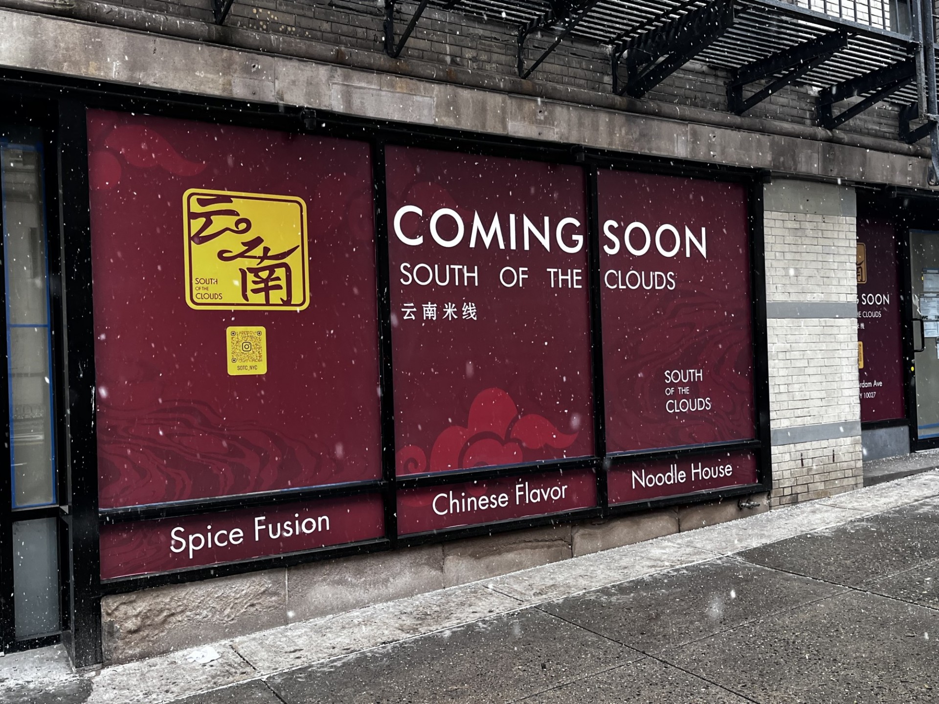 A window wrap that says, "Coming Soon: South of the Clouds. Spice Fusion, Chinese Flavor, Noodle House."