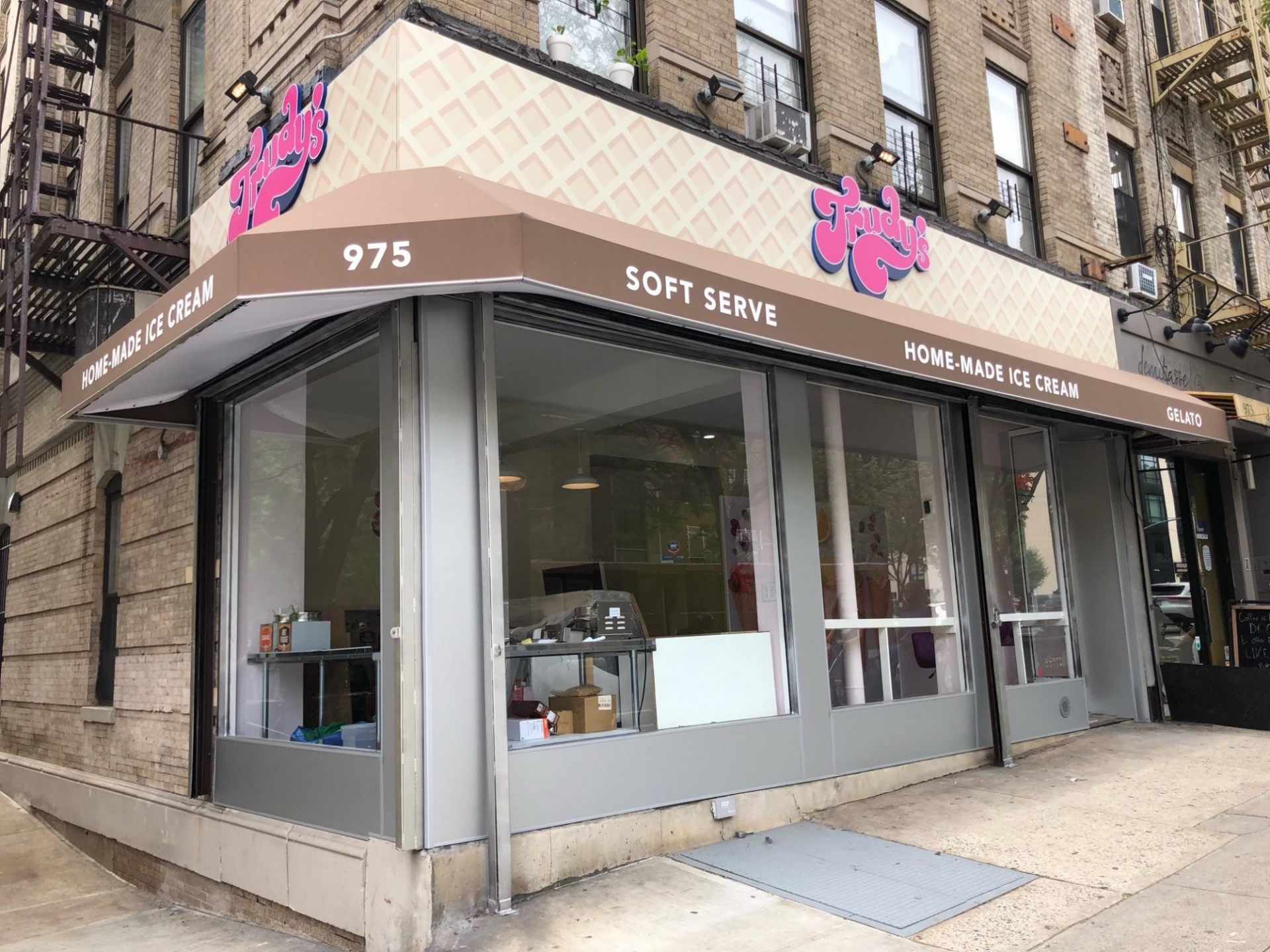 A storefront for Trudy's Ice Cream, with a waffle cone marque and Trudy's in big pink font.