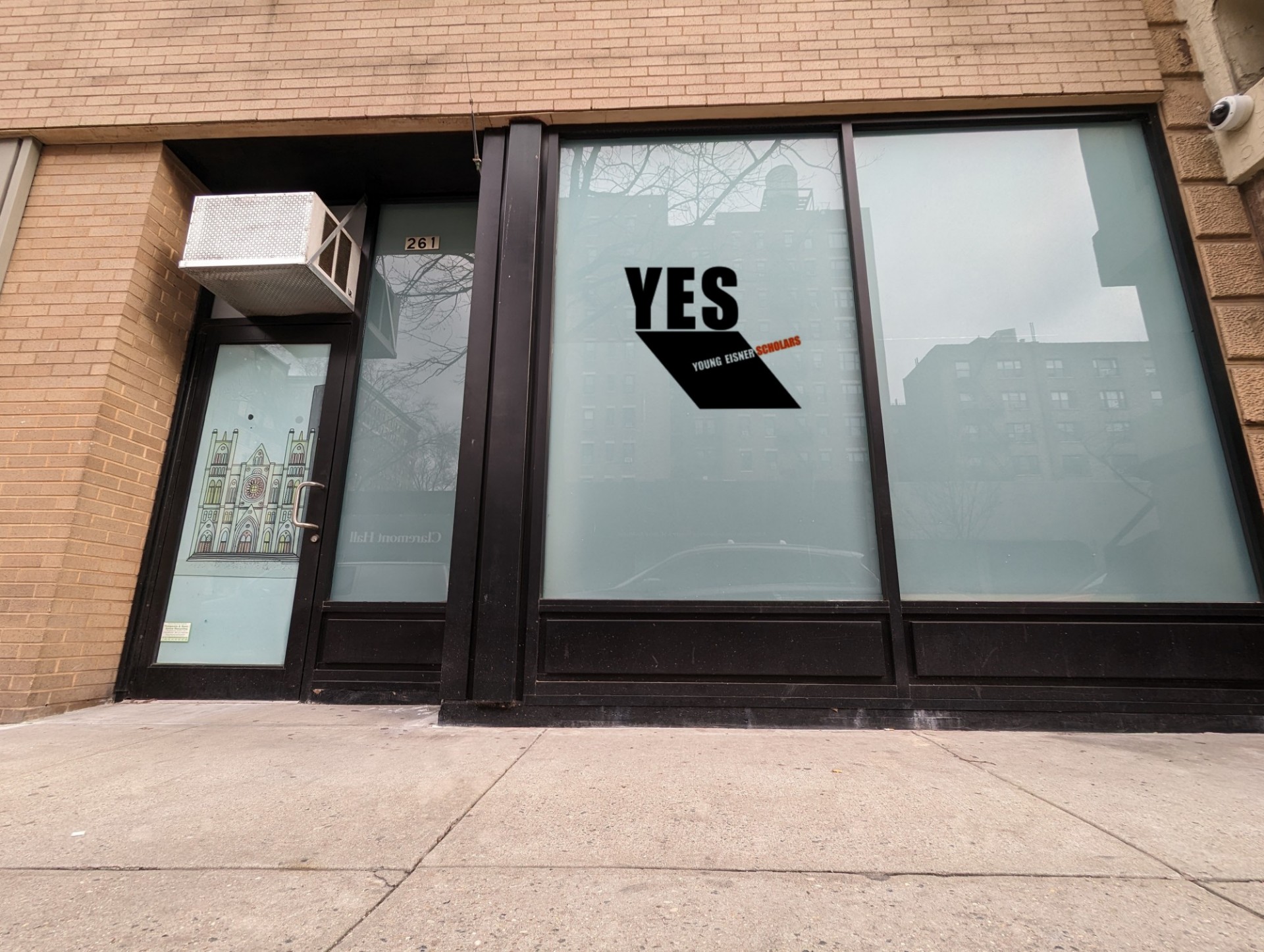 The storefront of YES that has frosted windows and the YES logo on it.
