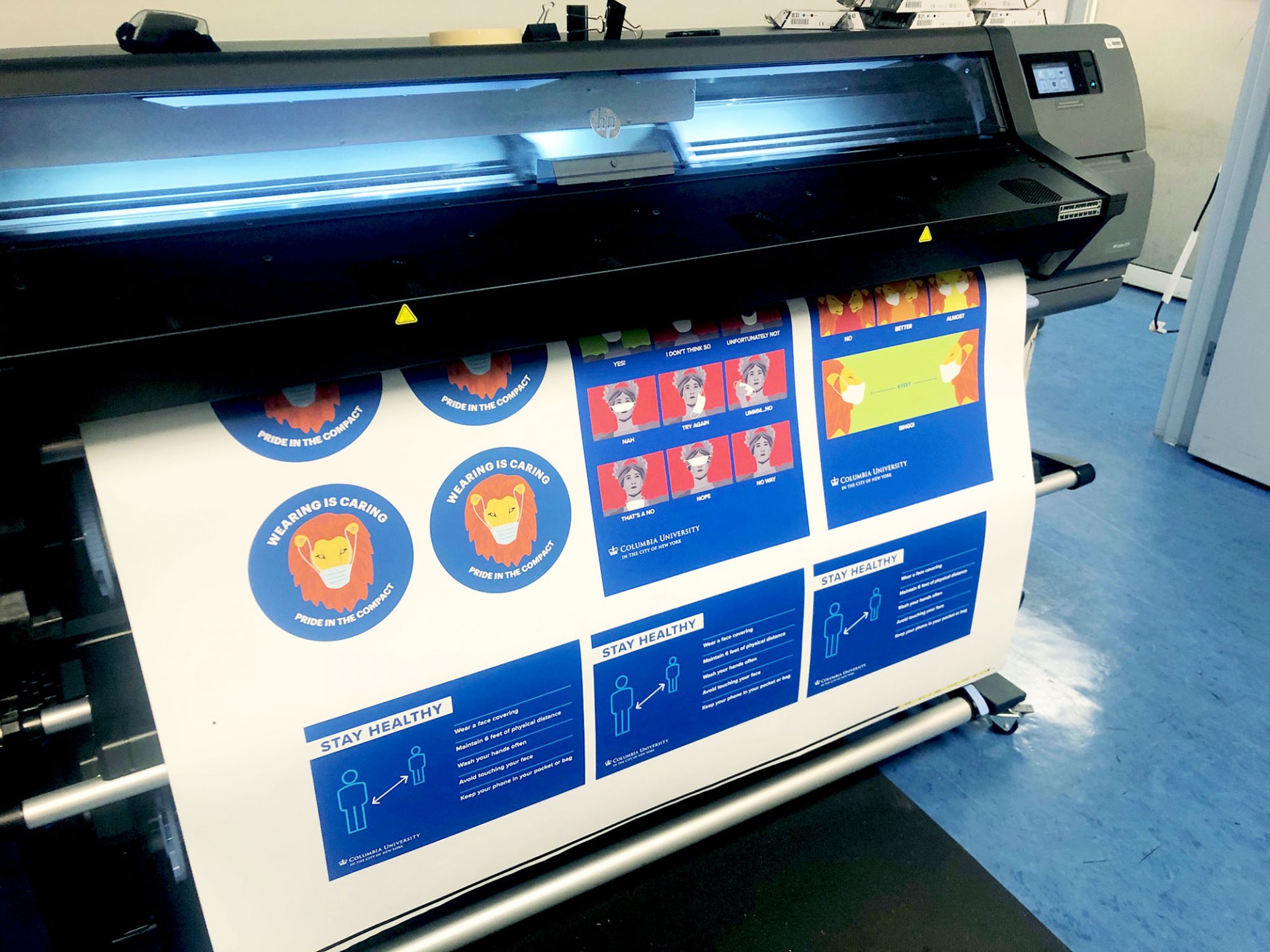 Printer showing a sheet of example images for stickers and postcards under the Stay Healthy campaign