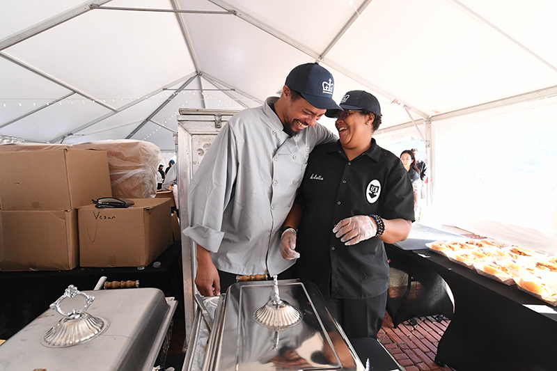 Eli & BB enjoying a good laugh Two staff laughing at a joke inside the event tent